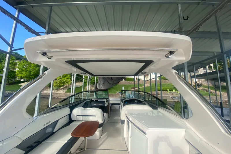 Slide: The Image of 2021 Regal 3300 Bowrider interior with seating and table under a covered dock. - 37