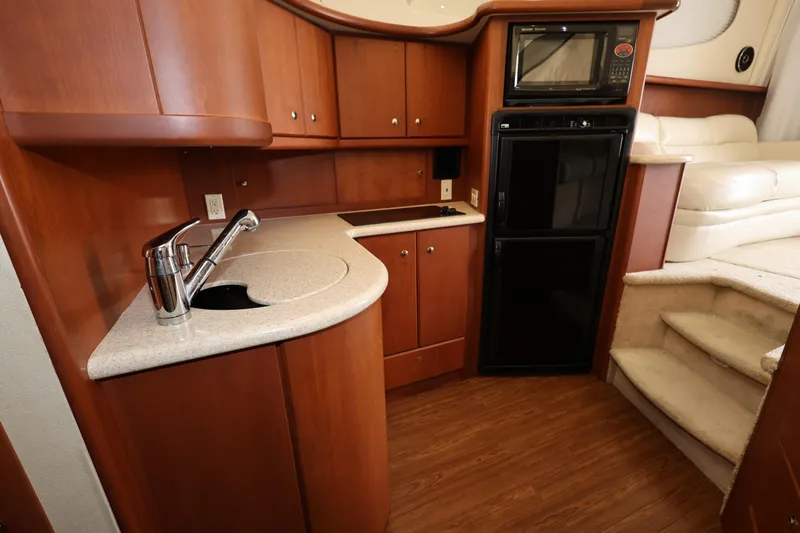 Slide: The Image of 2005 Silverton 34 Convertible yacht kitchen with wood cabinetry and modern appliances. - 12
