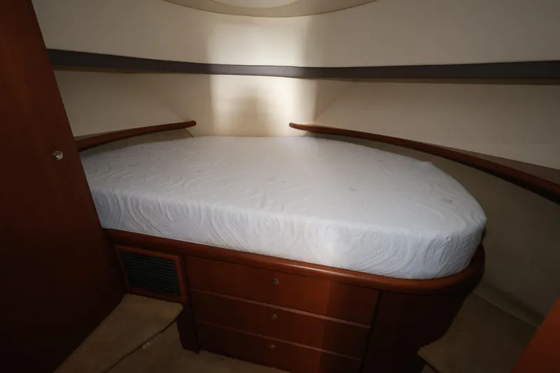 Slide: The Image of 2005 Silverton 34 Convertible yacht bedroom with a neatly made bed. - 13