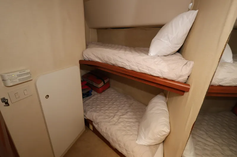 Slide: The Image of Bunk beds in 2005 Silverton 34 Convertible yacht cabin, featuring cozy bedding and compact design. - 16