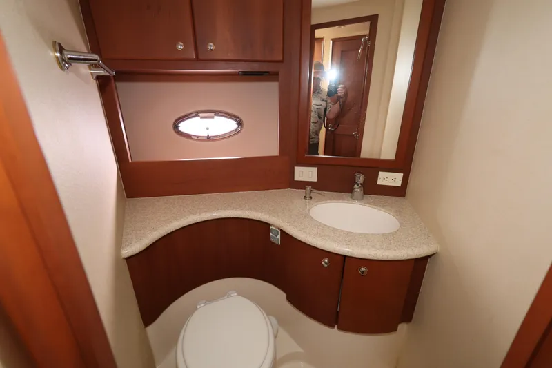 Slide: The Image of Bathroom interior of 2005 Silverton 34 Convertible yacht, featuring sink and toilet. - 17