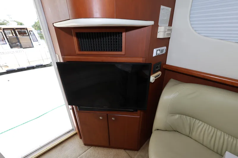 Slide: The Image of Interior of 2005 Silverton 34 Convertible yacht with TV and seating area. - 19