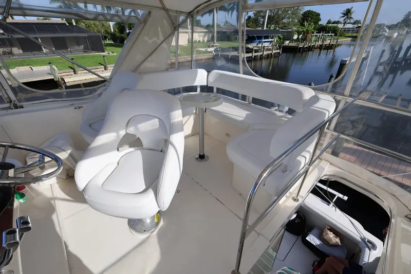 Slide: The Image of 2005 Silverton 34 Convertible yacht interior with white seating and steering wheel. - 22