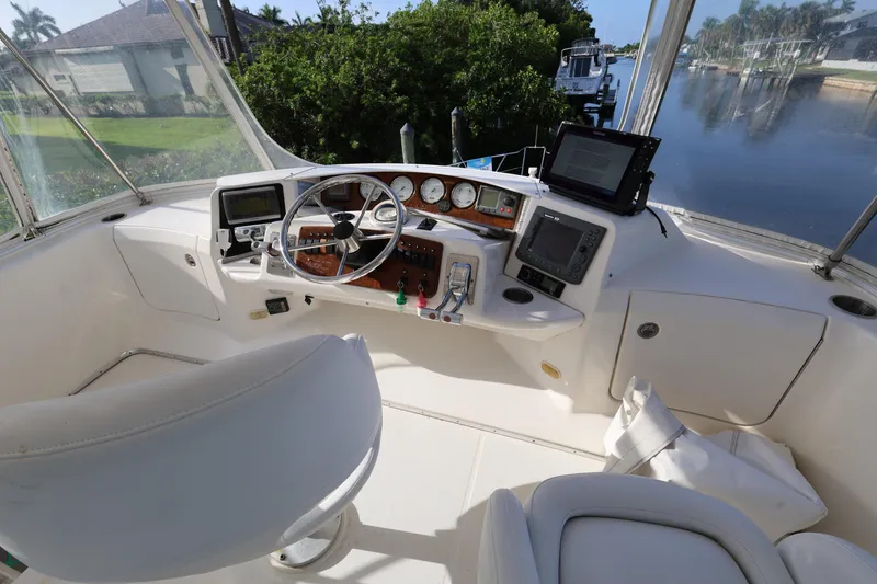 Slide: The Image of Helm of 2005 Silverton 34 Convertible yacht with steering wheel and navigation equipment. - 24