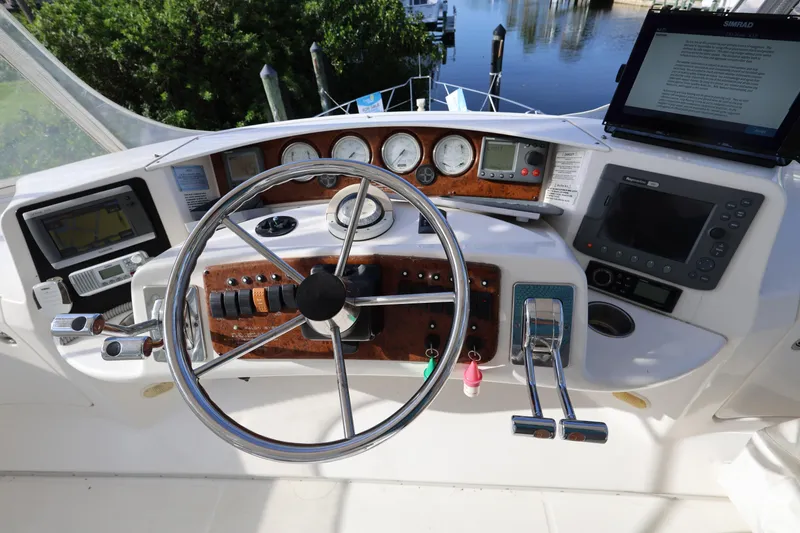 Slide: The Image of Helm of 2005 Silverton 34 Convertible boat with navigation equipment and controls. - 25