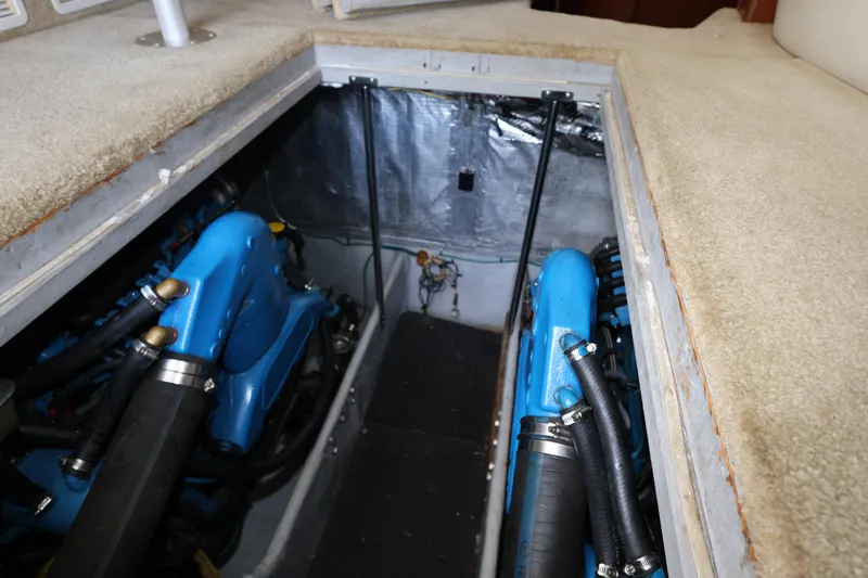 Slide: The Image of Engine compartment of a 2005 Silverton 34 Convertible boat, featuring blue engine components. - 28