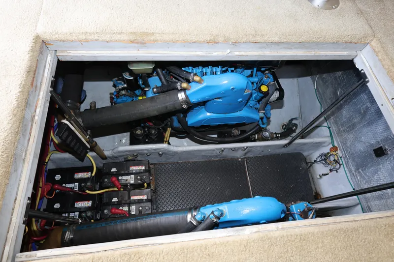 Slide: The Image of Engine compartment of a 2005 Silverton 34 Convertible boat, showcasing engine and battery setup. - 29