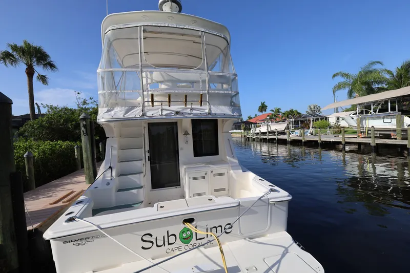 Slide: The Image of 2005 Silverton 34 Convertible yacht docked in a sunny marina setting. - 5