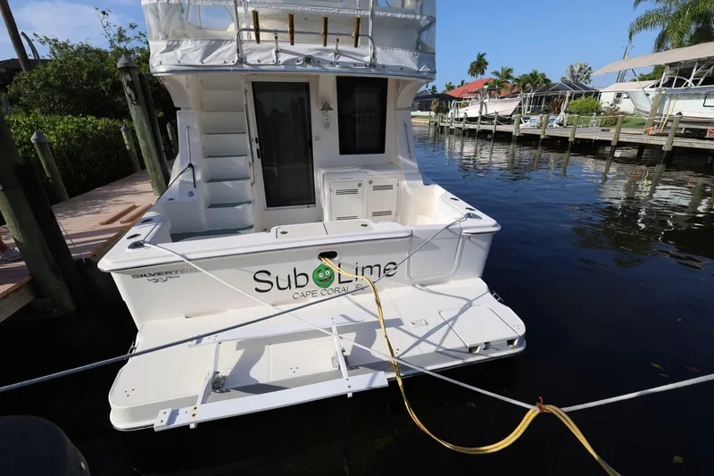 Slide: The Image of 2005 Silverton 34 Convertible boat docked, featuring "Sub Lime" branding, Cape Coral location. - 6