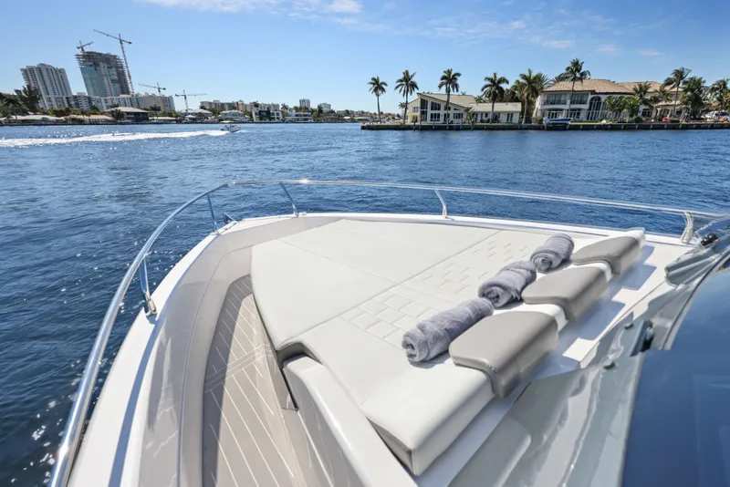 Slide: The Image of 2025 Valiatt 380 Bowrider cruising on a sunny waterfront with luxury homes. - 4