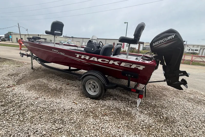 Slide: The Image of 2020 Tracker Pro 170 boat with Mercury engine on gravel lot. - 2