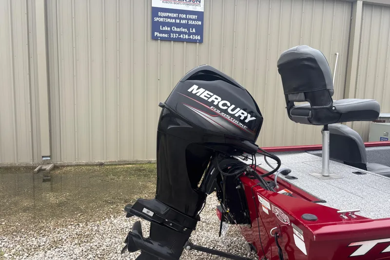 Slide: The Image of 2020 Tracker Pro 170 boat with Mercury FourStroke engine, parked near a building. - 3