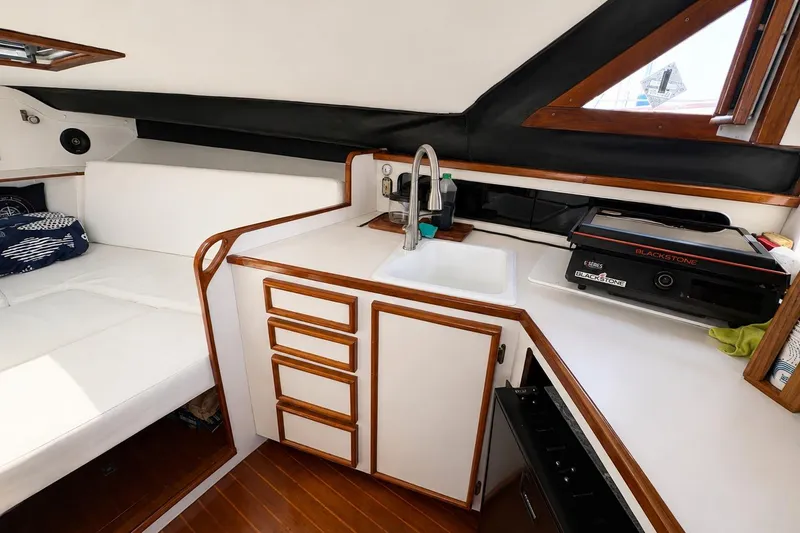 Slide: The Image of Interior of 1991 Blackfin 33 Flybridge with kitchenette and seating area. - 11