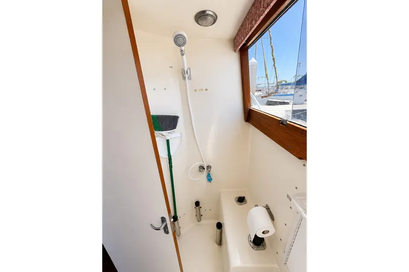 Slide: The Image of 1991 Blackfin 33 Flybridge boat bathroom with shower and window view. - 12