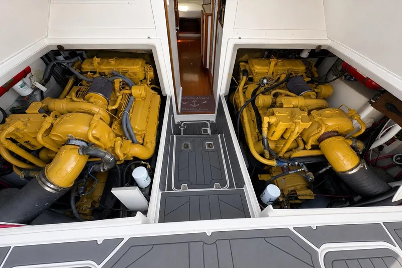 Slide: The Image of Engine room of a 1991 Blackfin 33 Flybridge with dual yellow engines. - 14