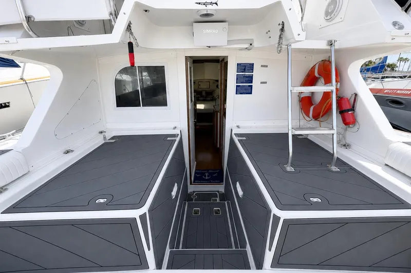Slide: The Image of 1991 Blackfin 33 Flybridge boat interior with gray deck, ladder, and safety equipment. - 2