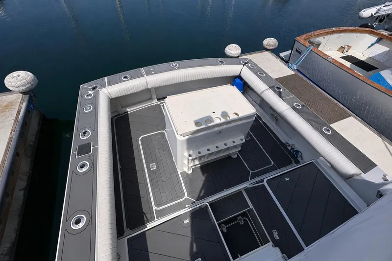 Slide: The Image of 1991 Blackfin 33 Flybridge boat deck with seating and storage, docked at marina. - 4