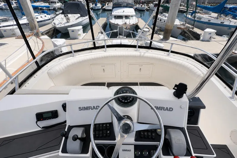 Slide: The Image of 1991 Blackfin 33 Flybridge boat helm with Simrad navigation, docked at marina. - 6