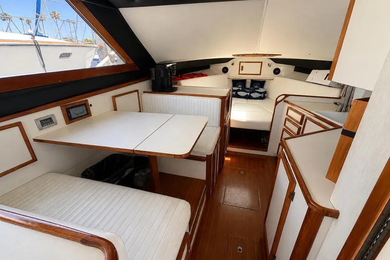 Slide: The Image of Interior of a 1991 Blackfin 33 Flybridge boat with wood accents and seating area. - 7