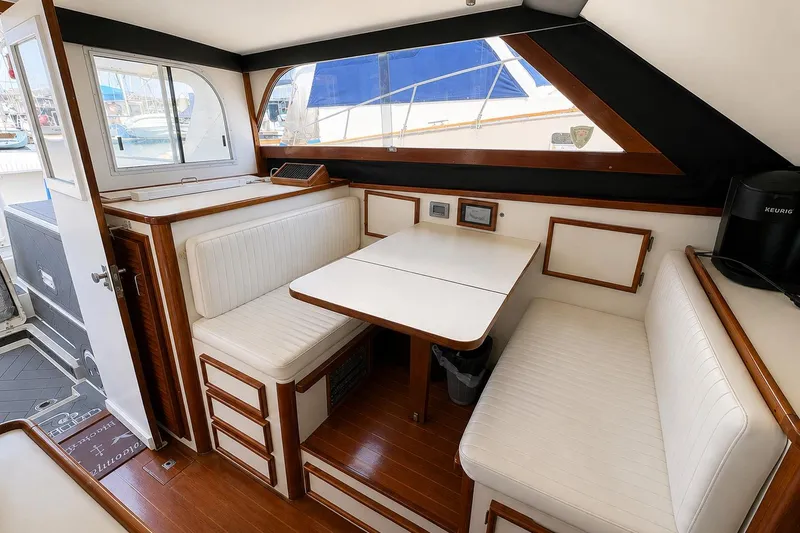 Slide: The Image of Interior of 1991 Blackfin 33 Flybridge with white seating and wooden accents. - 8