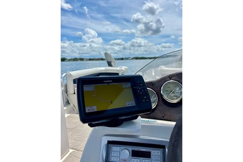 The Image of 2008 Hurricane FunDeck 226 RE boat dashboard with GPS navigation on a sunny day. - 1