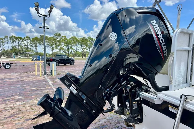 Slide: The Image of 2008 Hurricane FunDeck 226 RE with Mercury outboard motor in a parking lot. - 10