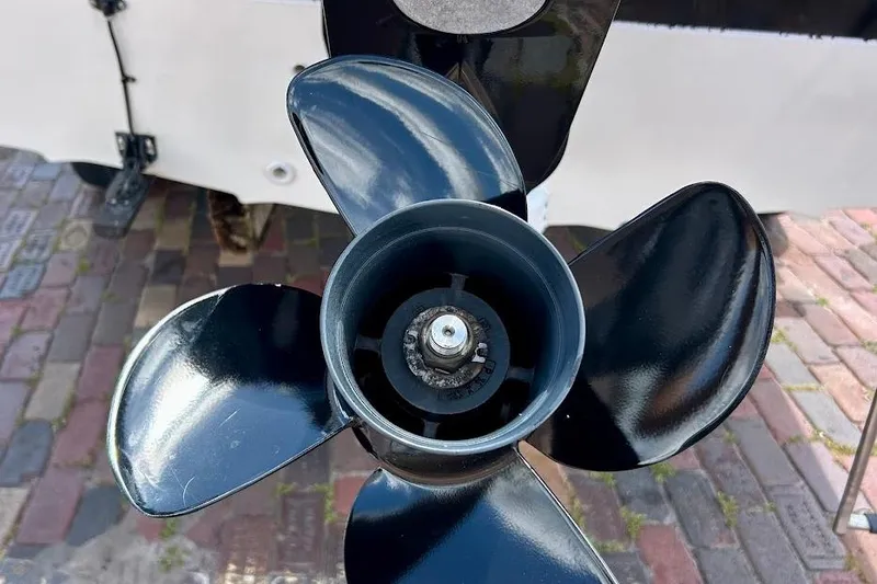 Slide: The Image of Close-up of a 2008 Hurricane FunDeck 226 RE boat propeller on a brick surface. - 12