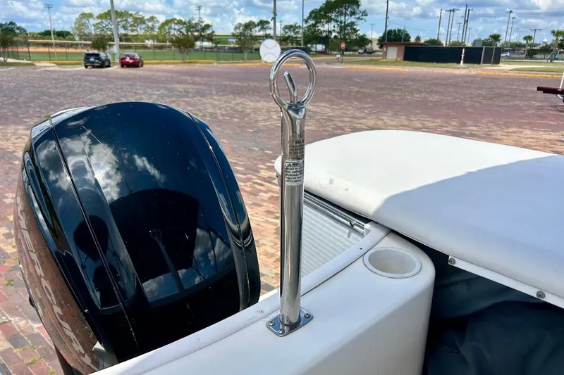 Slide: The Image of 2008 Hurricane FunDeck 226 RE boat with outboard motor and tow bar in a parking area. - 15