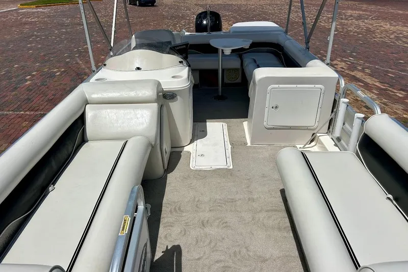 Slide: The Image of 2008 Hurricane FunDeck 226 RE interior with spacious seating and table on a sunny day. - 19