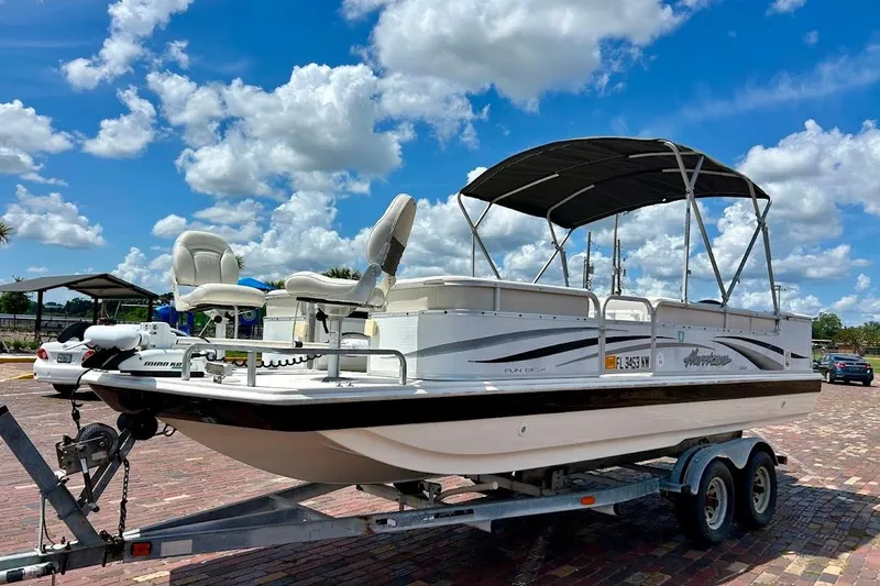 Slide: The Image of 2008 Hurricane FunDeck 226 RE boat on trailer under blue sky with clouds. - 2