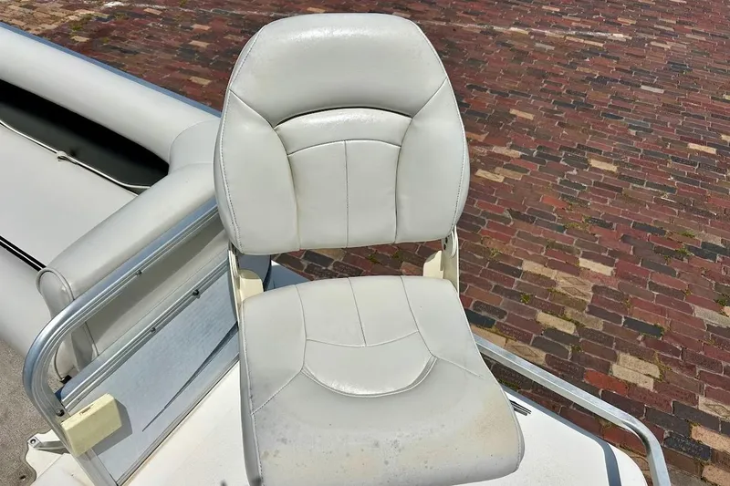 Slide: The Image of White captain's chair on 2008 Hurricane FunDeck 226 RE boat, brick background. - 20