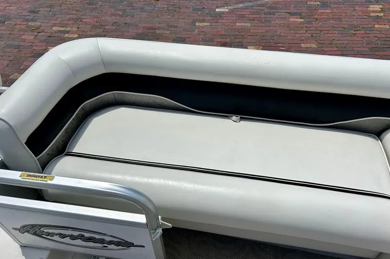Slide: The Image of 2008 Hurricane FunDeck 226 RE boat seating with white upholstery and logo detail. - 22