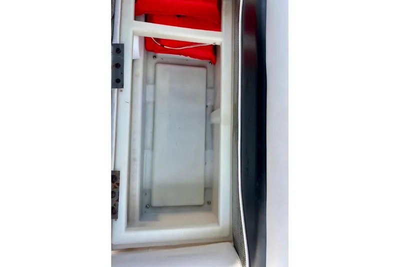 Slide: The Image of Storage compartment of a 2008 Hurricane FunDeck 226 RE boat with red life jackets. - 31