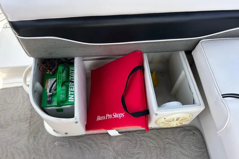 Slide: The Image of Storage compartment on 2008 Hurricane FunDeck 226 RE boat with battery and Bass Pro Shops cushion. - 32