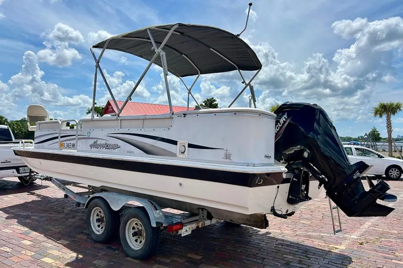Slide: The Image of 2008 Hurricane FunDeck 226 RE boat on trailer, with canopy and Mercury outboard motor. - 4