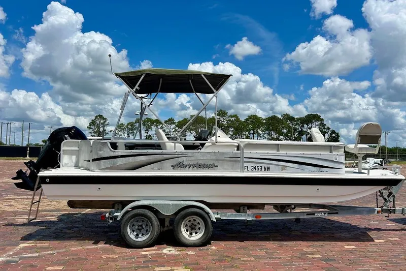 Slide: The Image of 2008 Hurricane FunDeck 226 RE boat on trailer under blue sky with clouds. - 7