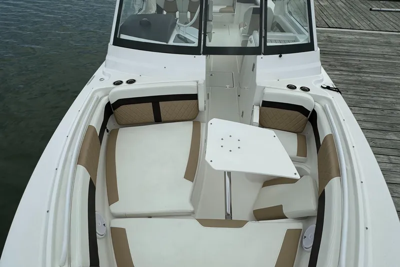 Slide: The Image of 2020 Edgewater 262 CX boat interior with seating and table. - 10