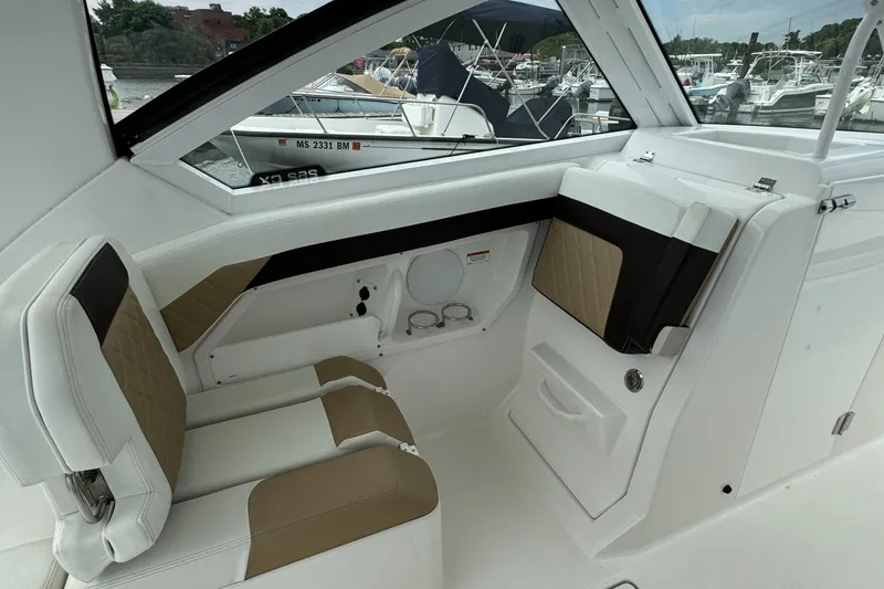 Slide: The Image of Interior of a 2020 Edgewater 262 CX boat with tan and white seating. - 11