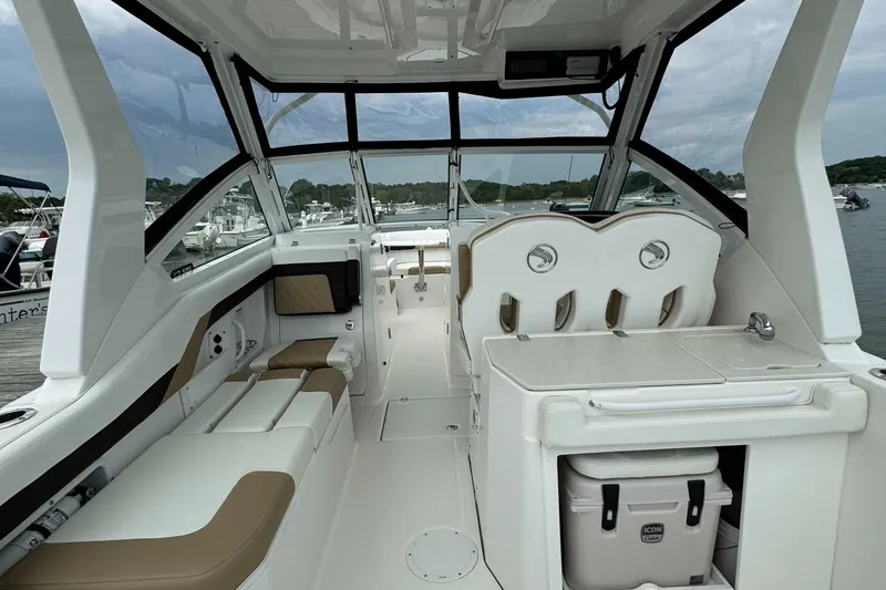 Slide: The Image of 2020 Edgewater 262 CX boat interior with seating and storage compartments. - 12