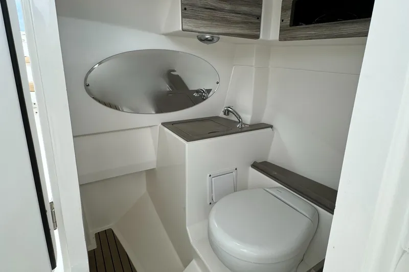 Slide: The Image of 2020 Edgewater 262 CX boat bathroom with sink and toilet. - 13