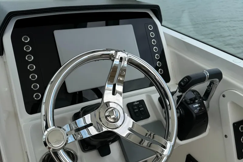 Slide: The Image of 2020 Edgewater 262 CX boat helm with modern controls and steering wheel. - 16