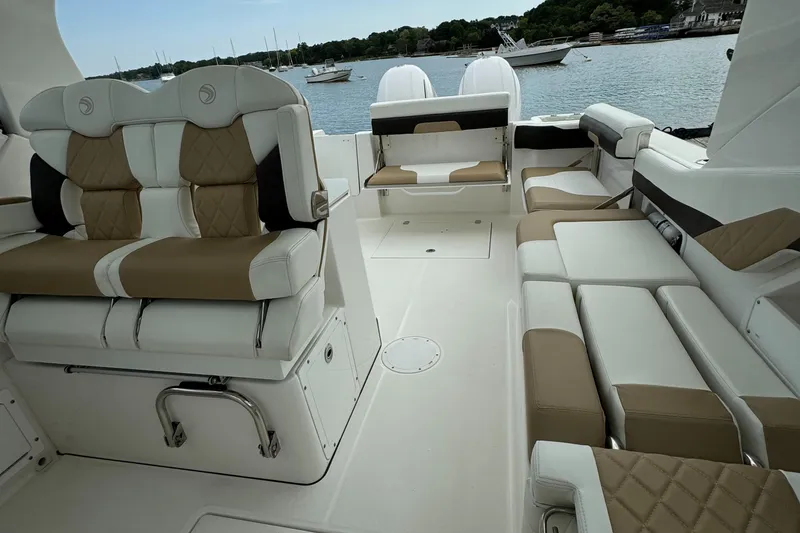 Slide: The Image of 2020 Edgewater 262 CX boat interior with luxurious seating and scenic water view. - 18
