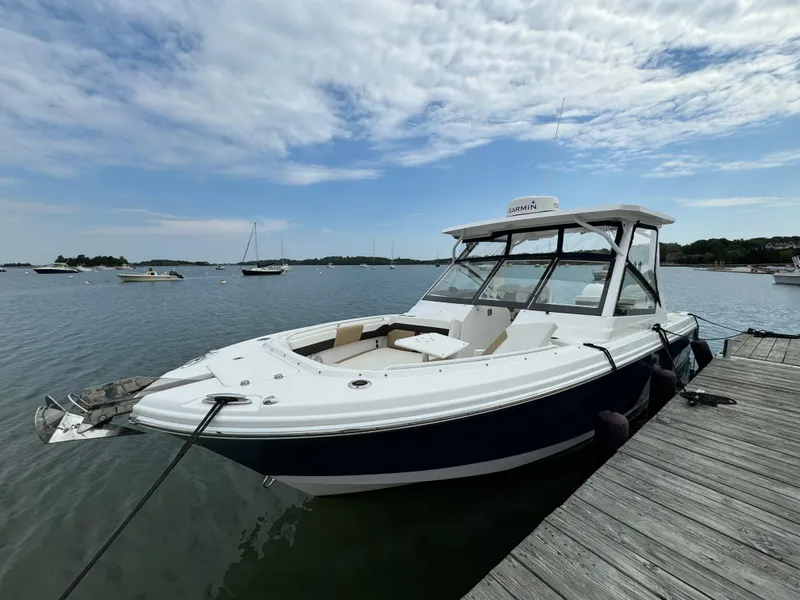 Slide: The Image of 2020 Edgewater 262 CX boat docked on a sunny day. - 2