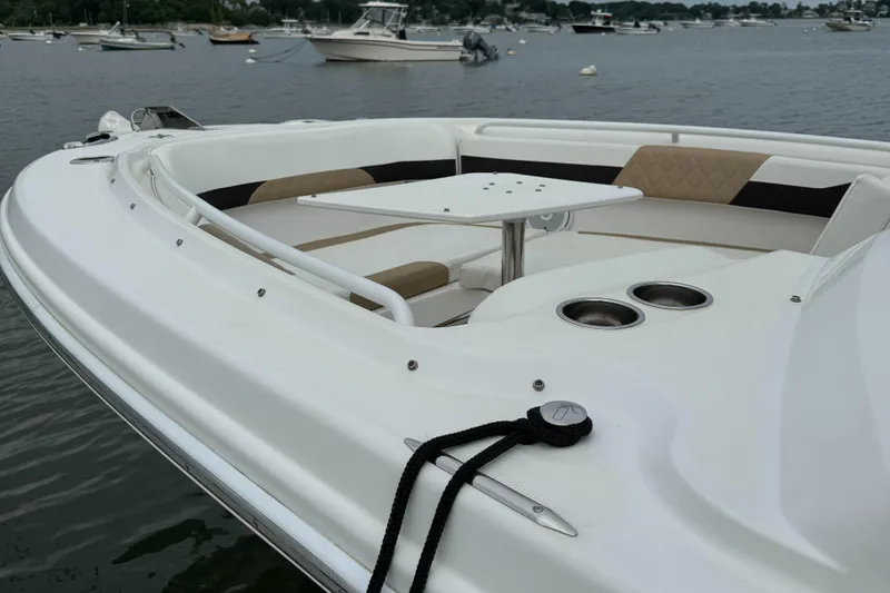 Slide: The Image of 2020 Edgewater 262 CX boat with spacious seating and table on calm waters. - 22