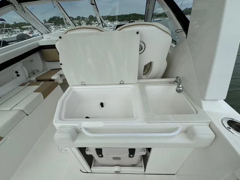 Slide: The Image of 2020 Edgewater 262 CX boat interior with sink and storage. - 7