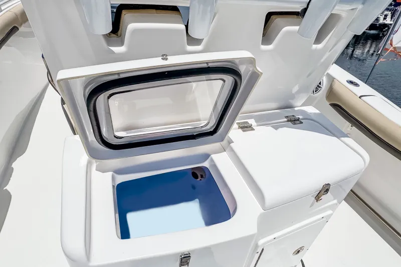 Slide: The Image of Open storage compartment on 2023 Tidewater 280 CC Adventure boat, featuring sleek design and functionality. - 14
