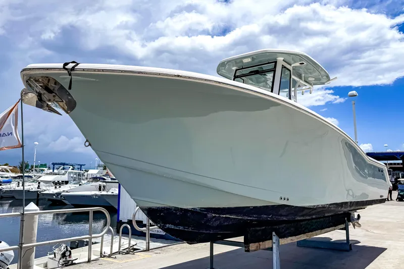 Slide: The Image of 2023 Tidewater 280 CC Adventure boat at the marina. - 2