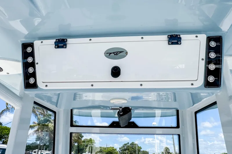 Slide: The Image of 2023 Tidewater 280 CC Adventure boat console with control panel and storage compartment. - 25