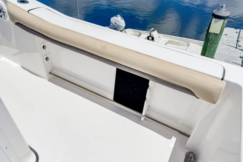 Slide: The Image of 2023 Tidewater 280 CC Adventure boat interior with cushioned seating and stainless steel railing. - 27