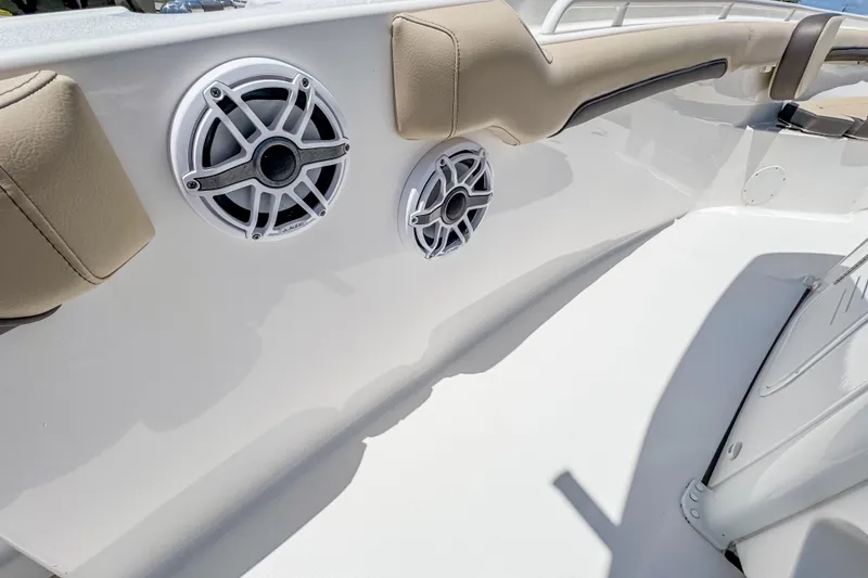Slide: The Image of 2023 Tidewater 280 CC Adventure boat interior with speakers and cushioned seating. - 28